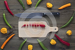 Chopped cayenne chilli pepper on cutting board with knife