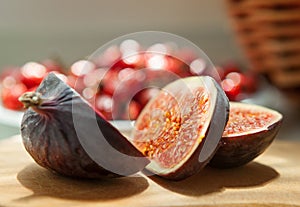 Chopped Fig fruits on the cutting board with briar (dog rose) on