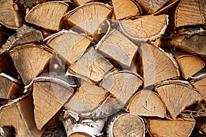 The chopped firewood lies in a pile intended for the fireplace