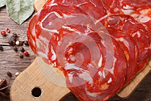 Chopped fresh chorizo sausage on a cutting board close up.