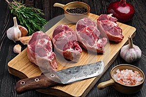 Chopped fresh lamb shank steak on cutting board with spice