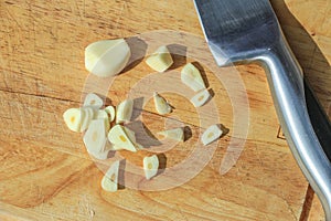 Chopped garlic with stainless steel knife nearby on a wooden cutting board. This was from a cooking lesson I took where we made de