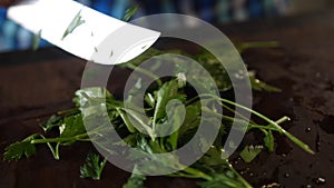 Chopped greens with knife on cutting board