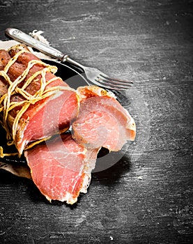 Chopped ham with a fork the old plate.