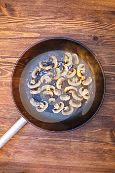 Chopped mushrooms fried champignon in a skillet in oil. frying pan heat