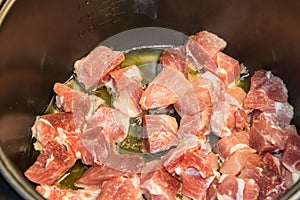 Chopped pork meat cooking in slow cooker