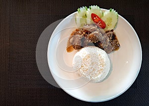 Chopped pork ribs fried with garlic gravy served with rice