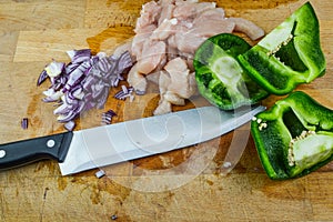 Chopped raw chicken meat, red onions and green peppers