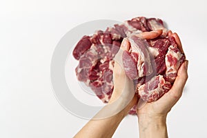 Chopped raw pork in hands. A woman holding fine cut pork meat a sign white background. Fine pork meat concept.