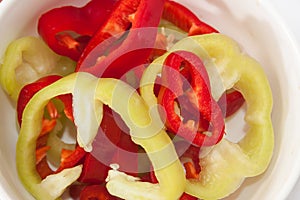 Chopped red and green peppers in a bowl