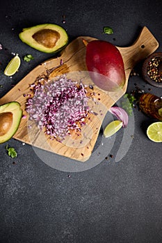 Chopped red Mars Onion on wooden cutting board at domestic kitchen