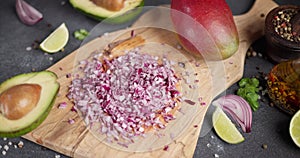 Chopped red Mars Onion on wooden cutting board at domestic kitchen