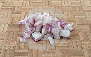 Chopped red onions on a wood cutting board