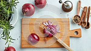 Chopped red onions on wooden cutting board