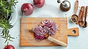 Chopped red onions on wooden cutting board