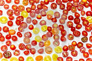 Chopped Scattered red and yellow tomatoes on a tray cooking ingredient.