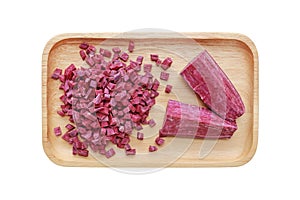 Chopped and sliced purple sweet potato in wood tray isolated on white background