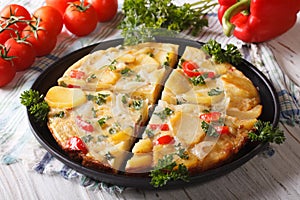 Chopped Spanish omelette with potatoes and vegetables close-up