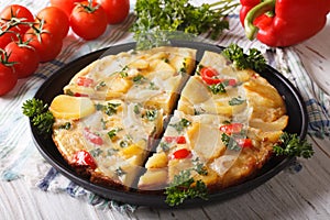 Chopped Spanish omelette with potatoes and vegetables close-up photo