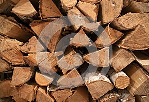 Chopped and stacked pile of pine and birch wood. Texture, background