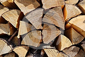 Chopped and stacked up dry firewood at the countryside. Stock pile of timber, chopped down trees