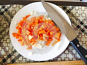 Chopped vegetables on a cutting table, carrots, onions