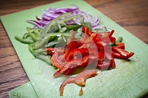 Chopped vegetables on kitchen table, preparing salad photo