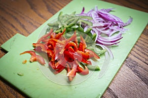 Chopped vegetables on kitchen table photo