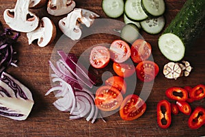 Chopped vegetables and mushrooms on cutting board