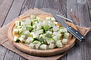 Chopped zucchini on wooden board