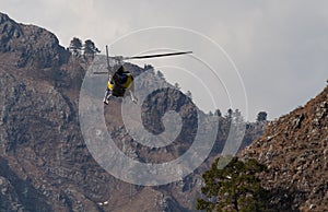 A Chopper flying from between mountain valley in rescue operation concept