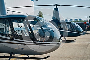 Choppers parked at vertiport on clear summer day photo