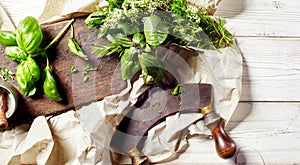 Chopping assorted fresh herbs with a mezzaluna photo