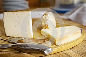 chopping board of various cheeses