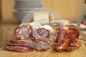 chopping board of various salamis