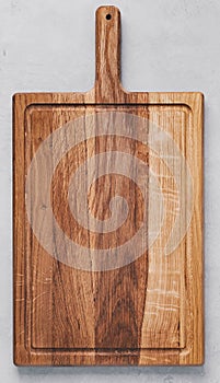 Chopping board. Wooden cutting board on gray concrete stone background. Top view, copy space