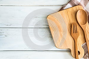 chopping board with wooden fork and spoon on white table , recipes food for healthy habits shot note background concept