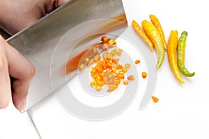 Chopping chillis on white cutting board photo