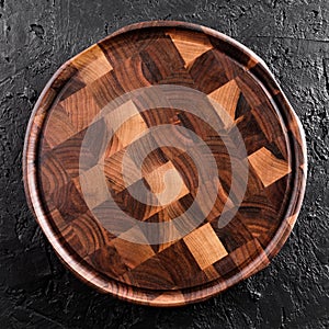 Chopping cutting board on dark stone background. Wooden texture. Top view