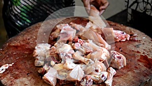 Chopping fresh chicken meat for cooking -close up