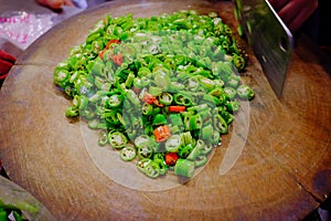 Chopping fresh Chilli pepper into pile of heart shape