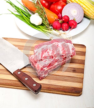 Chopping fresh pork ribs and vegetables