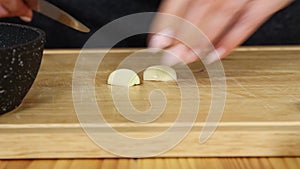 Chopping garlic on cutting board