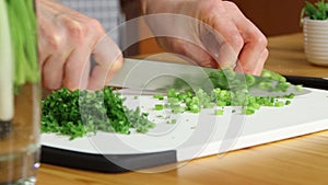 Chopping green onion on cutting board