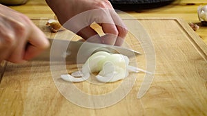 Chopping white onion on cutting board