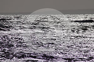 The choppy sea reflecting sunlight
