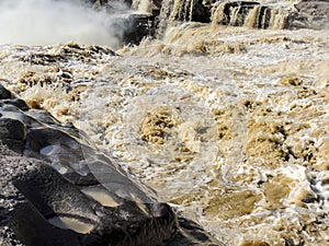 The choppy waters of the Yellow river with eroded rocks