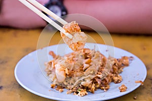 Chopstick holding big prawn from Penang Char Kuey Teow