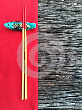 Chopstick on wood and red table cloth