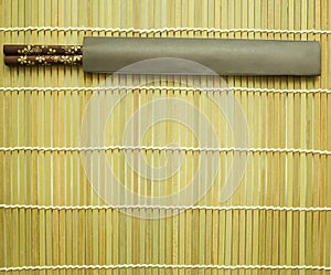 Chopsticks on bamboo matting background